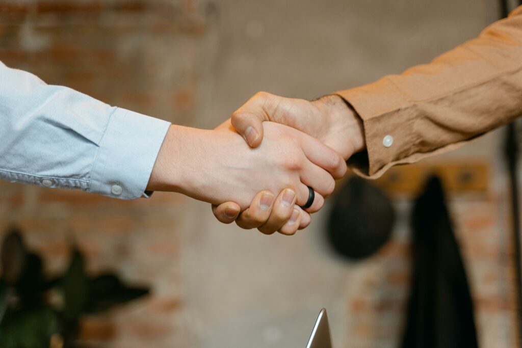 pexels-photo-7255731-7255731 Close-up of a firm handshake symbolizing a business deal agreement.